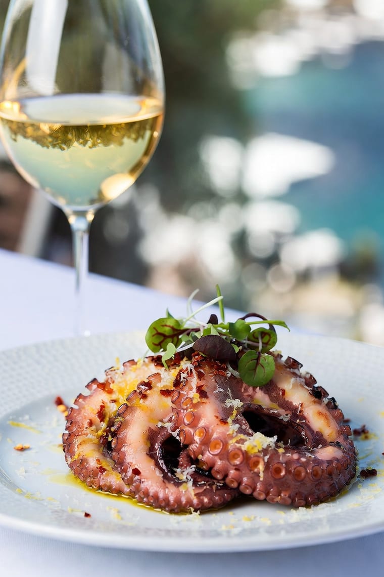 Grilled octopus with a glass of chilled white wine
