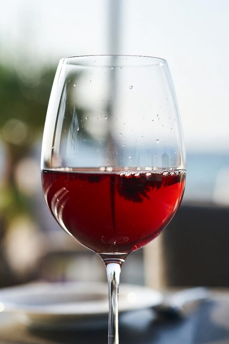 A glass of red wine overlooking the sea